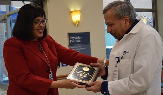 Photo of Dr. Hayek accepting the award from Cynthia Moore-Hardy. 