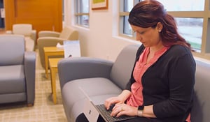 Image of woman completing hereditary cancer risk assessment questionnaire on tablet