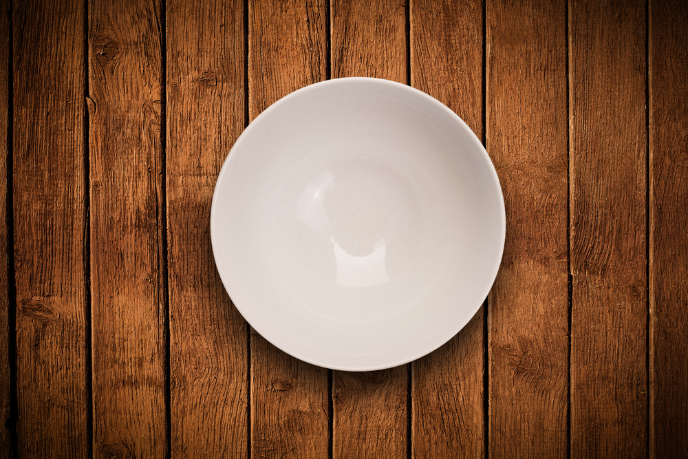 Colorful empty shiny plate on grungy background table